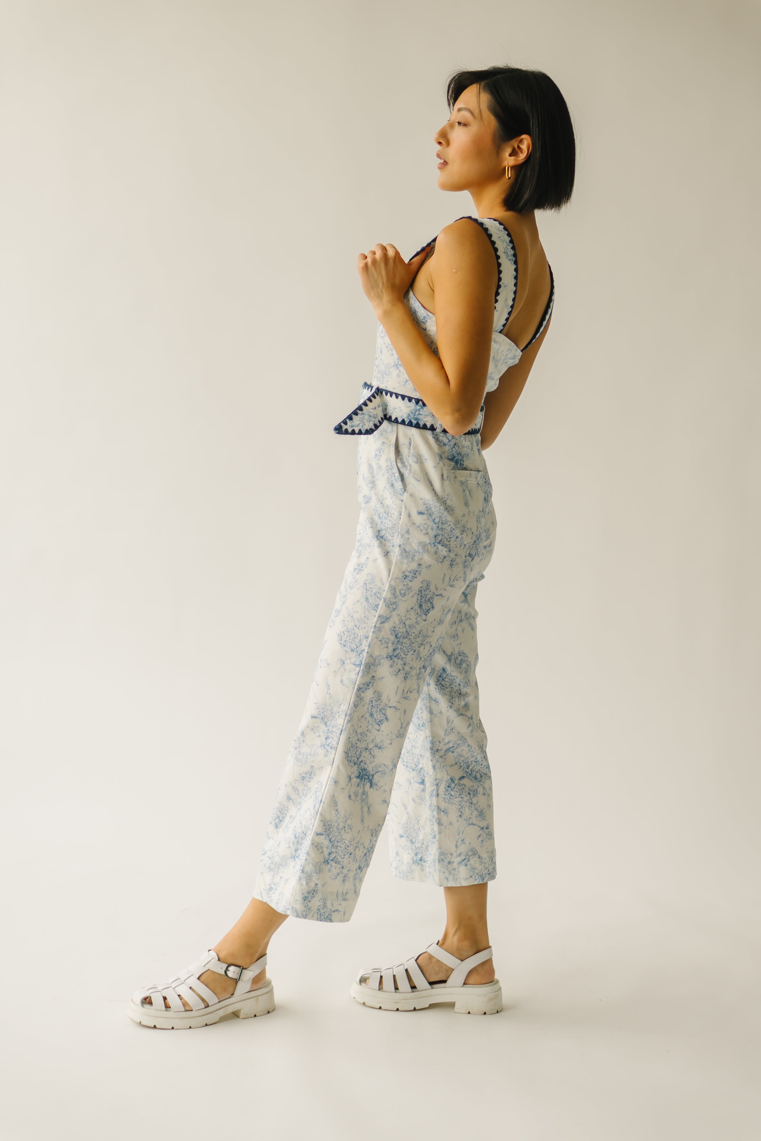 The Almada Belted Floral Jumpsuit in Ivory + Blue