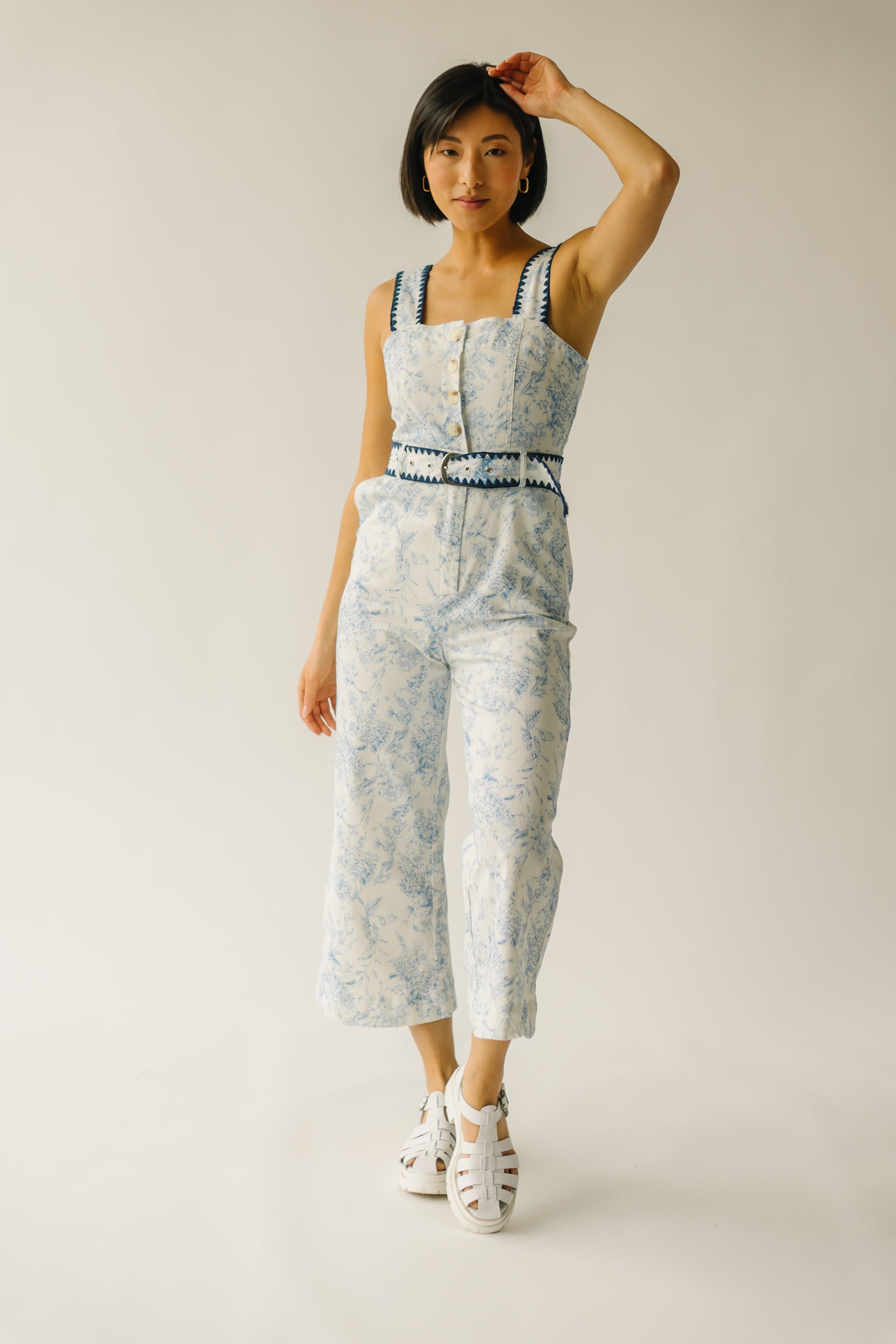 The Almada Belted Floral Jumpsuit in Ivory + Blue